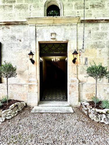 a door to a building with two trees in front of it at Maison La Galeze 