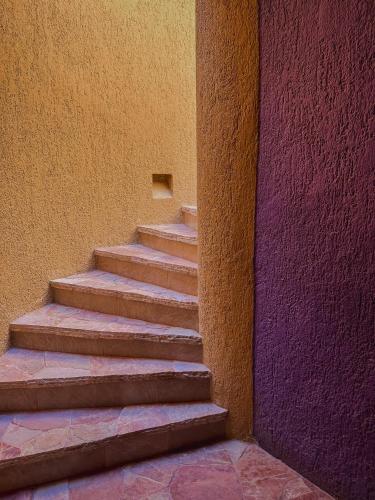 a set of stairs next to a wall at Hotel Los Patios in Cabo San Lucas