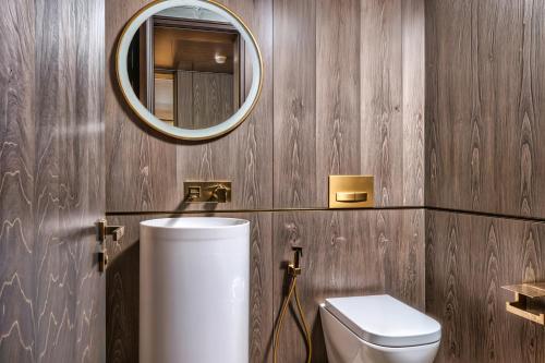 a bathroom with a toilet and a mirror at FIVE Palm Jumeirah Premier Apartments in Dubai