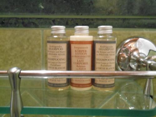 a shelf with four bottles of paint on it at Akasamia B&B - La Dimora in Itri