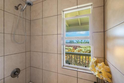 a bathroom with a shower and a window at 2 Mi to Hana Hwy Haiku Home with Ocean Views! in Haiku