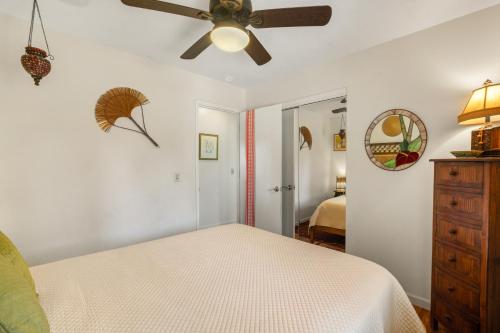 a bedroom with a ceiling fan and a bed at 2 Mi to Hana Hwy Haiku Home with Ocean Views! in Haiku