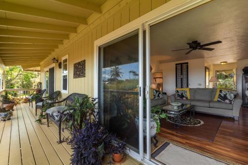 a porch of a house with a couch and a fan at 2 Mi to Hana Hwy Haiku Home with Ocean Views! in Haiku