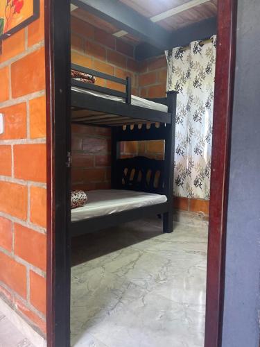 a room with two bunk beds in a brick wall at Aloha Campestre in San Rafael