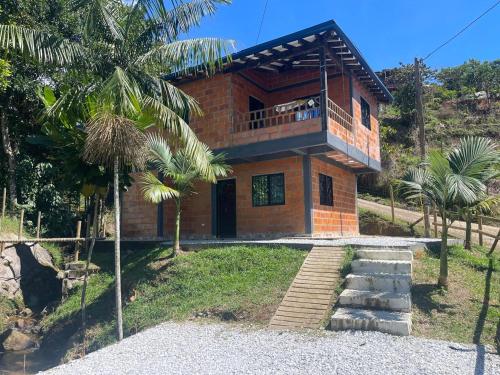 a house with a balcony on top of it at Aloha Campestre in San Rafael