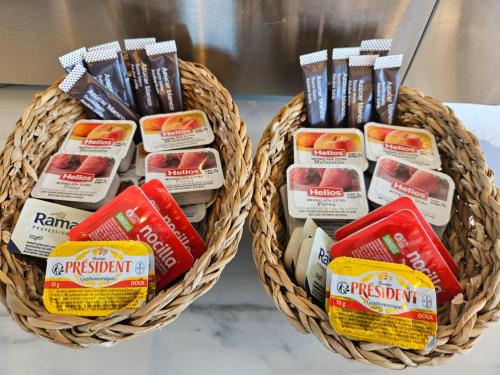 two baskets filled with different types of food at La Roqueta Hotel in Tossa de Mar