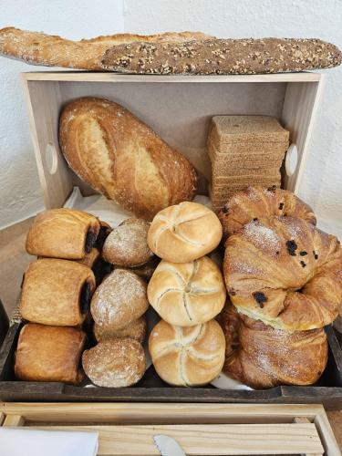 a box filled with different types of bread at La Roqueta Hotel in Tossa de Mar