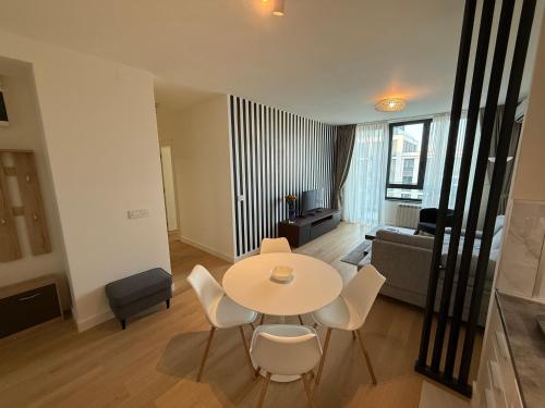 a living room with a table and chairs and a couch at BelgradeWATERFRONT - Apartments in Sajmište