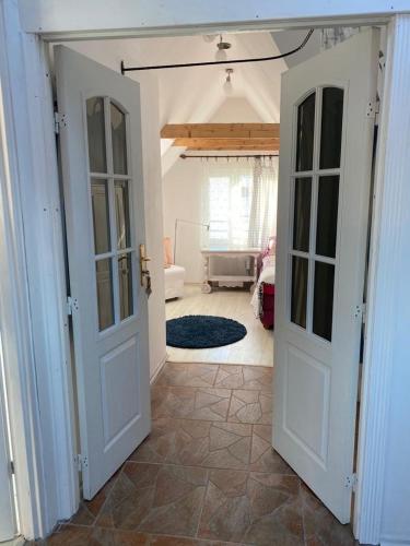 a hallway with two doors and a living room at Willa Róż Wisełka in Wisełka