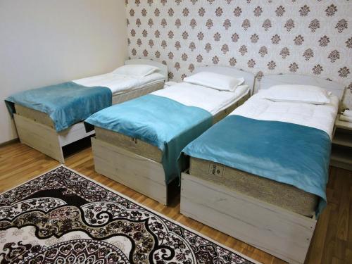 Postel nebo postele na pokoji v ubytování Guest House Ulukbek