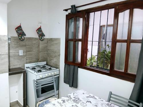 a kitchen with a stove and a window at Altos del Norte - Salta la Linda ! in Salta
