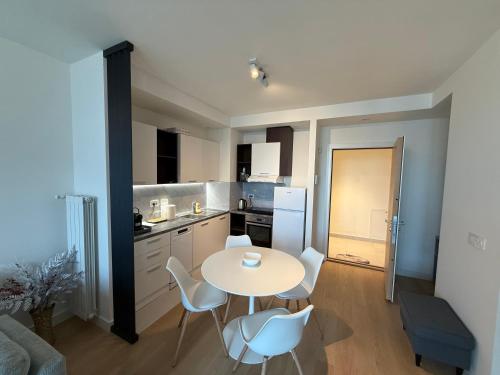 a small kitchen with a table and chairs in a room at BelgradeWATERFRONT - Apartments in Sajmište