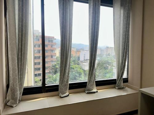 a window with a view of a city at Apartaestudios - Torre de Cali in Cali