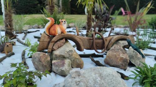 two toy animals sitting on top of some rocks at Maison N 2 Du Bas Coudreau in Rosnay