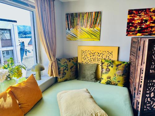 a living room with a couch and a window at Stylish free parking Studio central with balcony in Ålesund