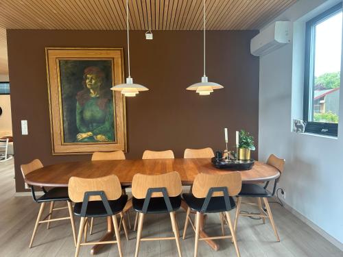 a dining room with a wooden table and chairs at Stort moderne hus- Sandnes Stavanger - Pulpit Rock in Sandnes
