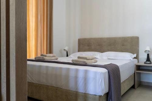a bedroom with a bed with towels on it at NS Apartments Nydri in Nydri