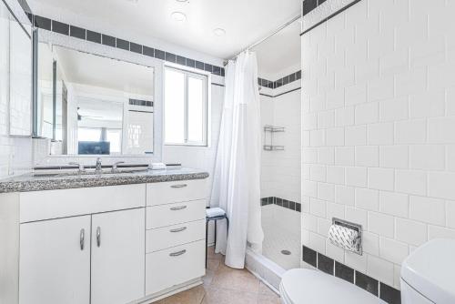 a white bathroom with a sink and a shower at Pet-Friendly 3Br Retreat One House From The Sand By Beachview Rentals in Newport Beach