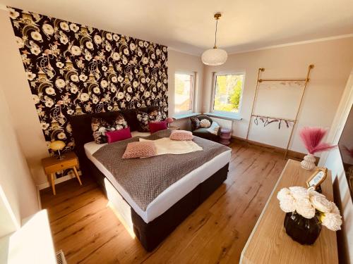 a bedroom with a bed and a couch at Ferienhaus Hugo in Lubmin