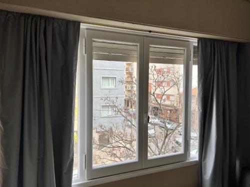 a window with a view of a building at El báltico in Mar del Plata