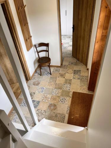 a stairway with a chair and a floor at Chalet Tomsine in Samoëns