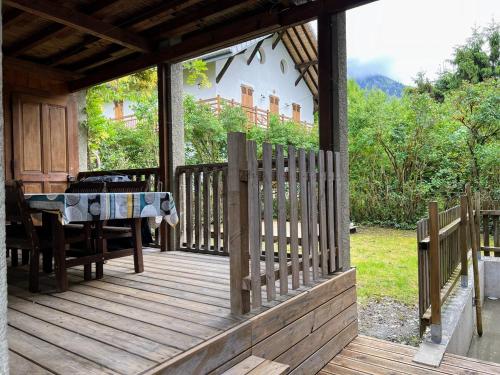a wooden deck with a table on a house at Chalet Tomsine in Samoëns