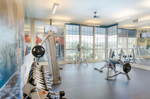 a gym with treadmills and machines in a room at Sunport Villas in Albuquerque