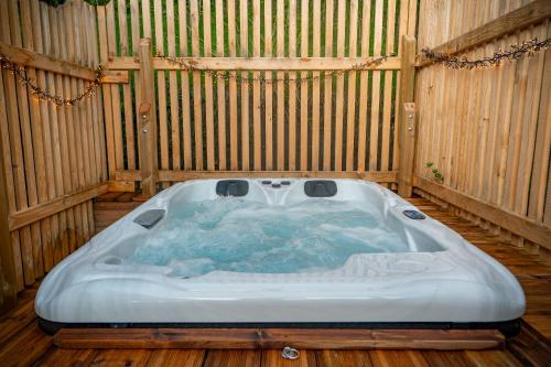 a jacuzzi tub in a wooden room at Les Lodges de la Valière in Chorges