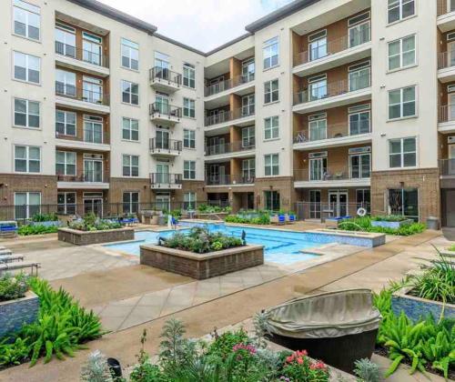 an apartment building with a pool and a courtyard at Relax & Enjoy In The City in Houston