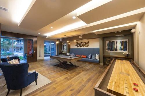 a large living room with a table and a couch at Relax & Enjoy In The City in Houston