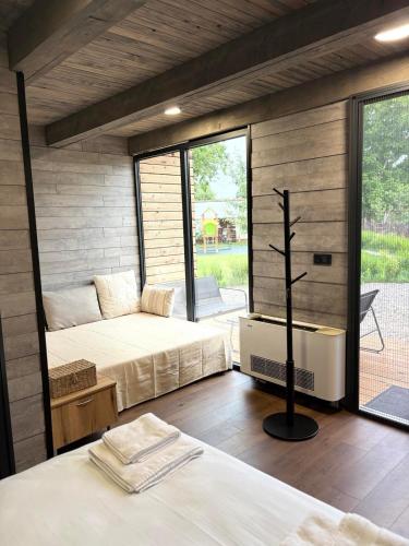a room with two beds and a cross in it at Slana bara glamping in Slana Bara