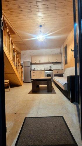 a room with a bed and a kitchen in a house at kotej lazi in Itʼkhvisi