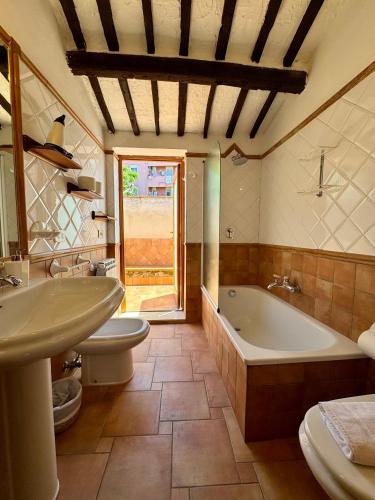 a bathroom with two toilets and a tub and a sink at Stunning Property with Private Pool in Cefalù in Cefalù