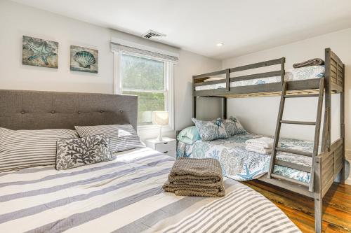 a bedroom with two bunk beds and a ladder at 4 Mi to Beach Cape Cod Retreat in Mashpee! in Mashpee