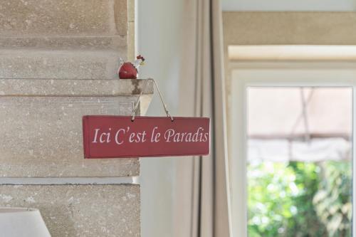a sign on the side of a building next to a window at L'ORANGERIE Chambres d'hotes de charme in Valros