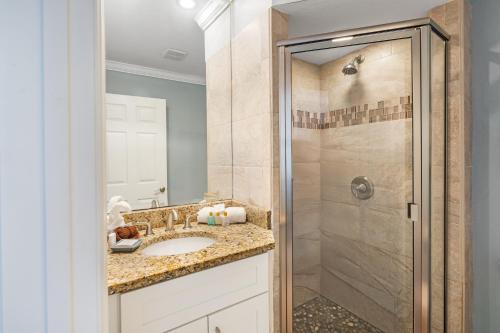 a bathroom with a sink and a shower at Tropical Beach Resorts - Sarasota in Sarasota