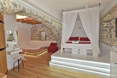a room with a bed with a window and a staircase at AMARE IL MARE Affittacamere e appartamenti in Corniglia