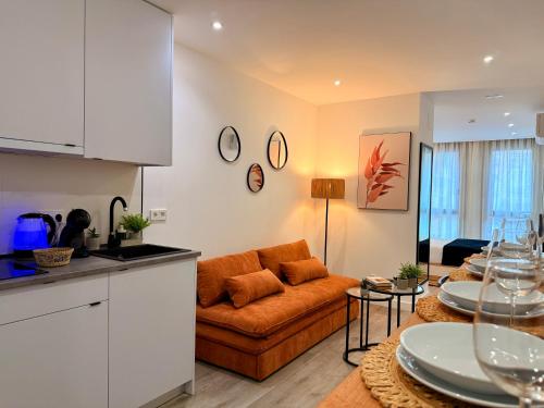 a kitchen and a living room with a couch at dozZze - Madrid Río in Madrid