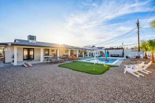 a house with a yard with a putting green at Havasu Fun Stay Pool Spa PoolTable KingBed in Lake Havasu City