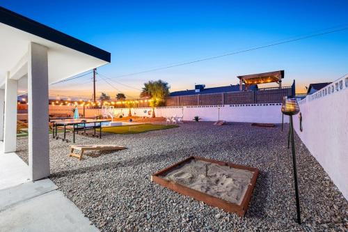 a building with a patio with a table and a fence at Havasu Fun Stay Pool Spa PoolTable KingBed in Lake Havasu City