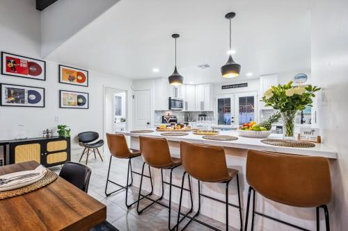 a kitchen with a large island with bar stools at Havasu Fun Stay Pool Spa PoolTable KingBed in Lake Havasu City