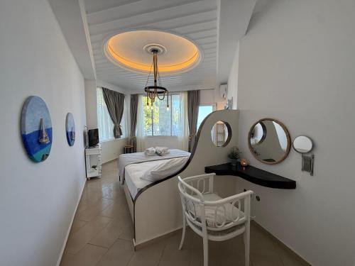 a room with a bed and a table and mirror at Amelia Seaview Apartments & Studios in Kallithea Halkidikis