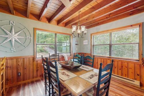 a dining room with a wooden table and chairs at DJ Bear Den in Bryson City