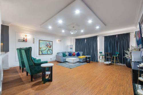a living room with a blue couch and chairs at WATER VIEW 3 BEDROOM APARTMENT WITH JACUZZI PARKING WiFi NETFLIX POOL in Lekki