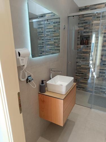 a bathroom with a sink and a shower at Lovely Sea View Apartments & Junior Suites in Himare