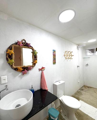 a bathroom with a toilet and a mirror on the wall at Suíte 3 - Village Capixaba in Gravatá
