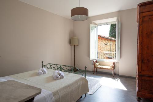 a bedroom with a bed and a window at The Clock Tower View Loft in Montecatini Alto