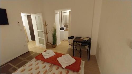 a room with a bed and a table and a chair at Apartman Lucija in Pirovac