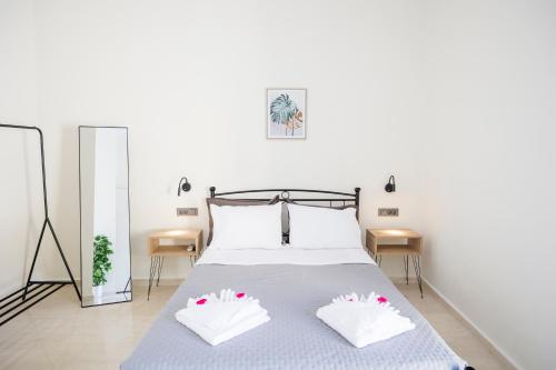 a bedroom with a bed with two pillows on it at Nikos StoneHouse in Prinés
