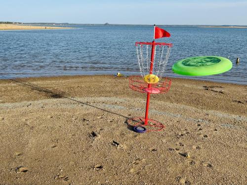 a red basket on the beach with a frisbee at Oasis Lake Buchanan in Bluffton